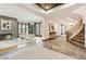 Open-concept living room with stone floors, fireplace and ample natural light at 325 Clayton St, Denver, CO 80206