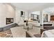 Bright living room featuring a modern fireplace, curved sofa, statement art, and stone flooring at 325 Clayton St, Denver, CO 80206