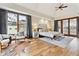 Bright main bedroom with sitting area, large windows, and a private outdoor patio at 325 Clayton St, Denver, CO 80206