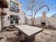Back patio with fireplace, fountain, and large outdoor table at 325 Clayton St, Denver, CO 80206