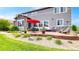 Large backyard patio featuring a dining set, lounge chairs, and lush landscaping at 3891 W 149Th Ave, Broomfield, CO 80023