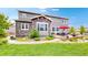 Well-maintained backyard featuring patio, dining area, manicured lawn, and mature trees at 3891 W 149Th Ave, Broomfield, CO 80023