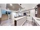Basement wet bar area with bar seating, wood floors, tray ceiling and finished staircase access at 3891 W 149Th Ave, Broomfield, CO 80023