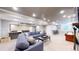 Finished basement with bar area, casual seating area with blue sectional and shuffleboard table at 3891 W 149Th Ave, Broomfield, CO 80023
