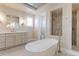 Bright bathroom featuring modern fixtures, soaking tub, walk-in shower, and a dual sink vanity at 3891 W 149Th Ave, Broomfield, CO 80023
