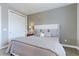 Comfortable bedroom with a closet, an upholstered headboard, and a soft, patterned bedspread at 3891 W 149Th Ave, Broomfield, CO 80023