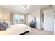 Serene bedroom with ample natural light, complemented by a dark wood dresser and a soft color palette at 3891 W 149Th Ave, Broomfield, CO 80023