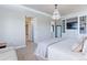 Elegant bedroom with decorative chandelier, built-in shelving, and neutral decor at 3891 W 149Th Ave, Broomfield, CO 80023