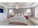 Elegant main bedroom featuring a tray ceiling, beautiful chandelier, and generous natural light at 3891 W 149Th Ave, Broomfield, CO 80023