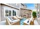 Cozy patio with stone fireplace, comfortable seating, and stylish blue striped rug at 3891 W 149Th Ave, Broomfield, CO 80023