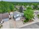 Expansive aerial view showcasing the well-manicured yard, mature trees, and the home's prime location at 13695 W 67Th Cir, Arvada, CO 80004