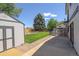Backyard showcasing a large yard, shed, and concrete patio, providing ample space for outdoor enjoyment at 13695 W 67Th Cir, Arvada, CO 80004