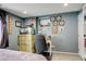 Cozy bedroom featuring a built-in desk, dresser, and personalized decor, creating a comfortable and inviting space at 13695 W 67Th Cir, Arvada, CO 80004