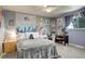 Cozy bedroom with a full bed, ceiling fan, and decorative wall art at 13695 W 67Th Cir, Arvada, CO 80004
