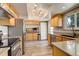 Modern kitchen featuring stainless steel appliances, sleek countertops, and hardwood floors at 13695 W 67Th Cir, Arvada, CO 80004