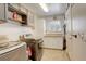 Functional laundry room with modern washer/dryer, storage cabinets, and counter space, perfect for household chores at 13695 W 67Th Cir, Arvada, CO 80004