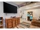Spacious living room boasts a large TV, vintage furniture, and an open layout perfect for relaxing and entertaining at 13695 W 67Th Cir, Arvada, CO 80004
