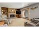 Comfortable living room featuring a brick fireplace, built-in shelves, and sliding glass doors to the exterior at 13695 W 67Th Cir, Arvada, CO 80004
