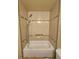 Clean bathroom shower featuring white tiling with decorative borders and a showerhead with detachable wand at 13695 W 67Th Cir, Arvada, CO 80004