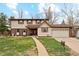 Charming two-story home with a well-manicured lawn and attached garage at 2410 S Lima St, Aurora, CO 80014