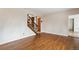 Spacious room with hardwood floors and a staircase leading to the upper level at 2410 S Lima St, Aurora, CO 80014