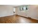 Bright living room with hardwood floors and a large window with decorative curtains at 2410 S Lima St, Aurora, CO 80014