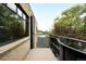 Exterior view of a balcony with brick siding, black railing, and city views at 636 N Washington St # 301, Denver, CO 80203
