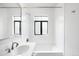 Bright bathroom featuring subway tile, tub, and window at 636 N Washington St # 301, Denver, CO 80203