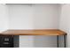 Close-up of a built-in desk featuring a wooden countertop and black metal cabinet at 636 N Washington St # 301, Denver, CO 80203