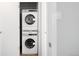 Modern, stacked washer and dryer unit in a closet with white walls at 636 N Washington St # 301, Denver, CO 80203