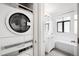 Bathroom with laundry featuring stacked washer/dryer and vanity with a tub at 636 N Washington St # 301, Denver, CO 80203