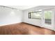 Bright living room featuring hardwood floors, large window, and balcony access at 636 N Washington St # 301, Denver, CO 80203