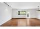 Bright living room featuring hardwood floors, a large window, and a door to the outside at 636 N Washington St # 301, Denver, CO 80203