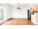 Open living area featuring hardwood flooring, stainless steel fridge, and partial kitchen view at 636 N Washington St # 301, Denver, CO 80203