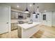 Modern kitchen with gray cabinets, quartz countertops, and stainless steel appliances at 8508 Silverton Ln, Littleton, CO 80125