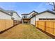 View of backyard with a wooden fence and a covered patio with folding glass doors at 2056 S Ogden St, Denver, CO 80210