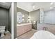 Spa-like bathroom featuring a soaking tub, walk-in shower, and dual sinks at 2056 S Ogden St, Denver, CO 80210