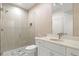 This bathroom has a toilet, vanity, sink, mirror and a shower with clear glass door at 2056 S Ogden St, Denver, CO 80210