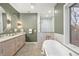 Luxurious bathroom with double vanity, soaking tub, walk-in shower, and stylish finishes at 2056 S Ogden St, Denver, CO 80210