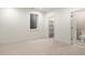Bright bedroom with a window, carpeted floors, and a closet and bathroom nearby at 2056 S Ogden St, Denver, CO 80210
