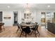 Bright dining room with a modern chandelier, wet bar, and access to the outdoor patio at 2056 S Ogden St, Denver, CO 80210