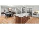Open kitchen with large island, farmhouse sink, stainless steel appliances and hardwood floors at 2056 S Ogden St, Denver, CO 80210