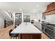Bright kitchen with oversized island, stainless steel appliances and hardwood floors at 2056 S Ogden St, Denver, CO 80210