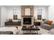 Cozy living room featuring a brick fireplace, hardwood floors, and comfortable seating at 2056 S Ogden St, Denver, CO 80210