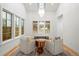 Cozy living room with bright chandelier, large windows, and hardwood floors at 2056 S Ogden St, Denver, CO 80210