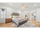 Beautifully appointed primary bedroom showcasing neutral tones, a ceiling fan, and a large, decorative mirror at 2056 S Ogden St, Denver, CO 80210