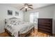 Bright bedroom with ceiling fan and dresser at 7933 York St # 1, Denver, CO 80229