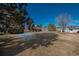 Community green space with homes and trees in background at 7933 York St # 1, Denver, CO 80229