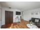 Entryway with coat closet, console table, and hardwood floors at 7933 York St # 1, Denver, CO 80229