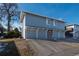Gray building with three attached garages and driveway at 7933 York St # 1, Denver, CO 80229